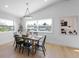 Elegant dining room featuring modern lighting, stylish furniture, and ample natural light at 616 Fern St, Anna Maria, FL 34216