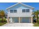 Exterior elevation shows the two-story construction, 2-car garage, and coastal color scheme at 616 Fern St, Anna Maria, FL 34216