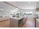 Large kitchen with spacious island, hardwood floors, stainless steel appliances, and natural light at 616 Fern St, Anna Maria, FL 34216