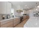 Bright kitchen featuring marble countertops, stainless steel appliances, and modern cabinetry at 616 Fern St, Anna Maria, FL 34216