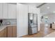 Modern kitchen with stainless steel refrigerator, white cabinets, and stylish countertops at 616 Fern St, Anna Maria, FL 34216