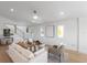 Bright living room with contemporary furniture, light hardwood floors, and ample natural light at 616 Fern St, Anna Maria, FL 34216
