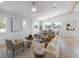 Bright living room with modern decor, dining area, and hardwood floors at 616 Fern St, Anna Maria, FL 34216