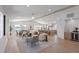 Open-concept living room, with dining area, kitchen, and light hardwood floors at 616 Fern St, Anna Maria, FL 34216