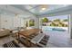 Outdoor dining area with a striped rug, table, an outdoor living area and pool at 616 Fern St, Anna Maria, FL 34216