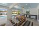 Outdoor dining area featuring a built-in grill, mounted tv, and an outdoor living space with a pool view at 616 Fern St, Anna Maria, FL 34216