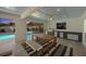 Outdoor kitchen and dining area with a built-in grill, bar seating, and views of the pool at 616 Fern St, Anna Maria, FL 34216