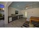 Outdoor kitchen featuring a built-in grill and storage, with a dining area and views of the yard at 616 Fern St, Anna Maria, FL 34216