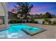 Backyard pool and spa surrounded by a well-kept patio and a privacy fence with mature landscaping at 616 Fern St, Anna Maria, FL 34216