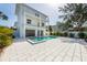 Exterior view of the rear of the property, featuring a pool, spa, patio, and multiple balconies at 616 Fern St, Anna Maria, FL 34216