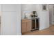 Convenient wet bar with wine fridge, marble countertop, and modern cabinets for entertaining at 616 Fern St, Anna Maria, FL 34216