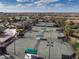 Aerial view of multiple tennis courts in a residential community, complete with shaded areas and meticulous landscaping at 6509 Grand Estuary Trl # 201, Bradenton, FL 34212