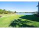 Picturesque backyard featuring a tranquil pond and manicured lawn at 6509 Grand Estuary Trl # 201, Bradenton, FL 34212