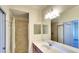 Well-lit bathroom features tiled shower, vanity and large mirror at 6509 Grand Estuary Trl # 201, Bradenton, FL 34212