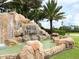 Beautiful River Strand community entrance featuring a waterfall and lush landscaping at 6509 Grand Estuary Trl # 201, Bradenton, FL 34212