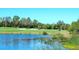 Picturesque golf course with a pond and lush greenery, showcasing a scenic and well-maintained landscape at 6509 Grand Estuary Trl # 201, Bradenton, FL 34212