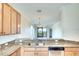 Open kitchen with stainless steel appliances, granite countertops overlooking living area at 6509 Grand Estuary Trl # 201, Bradenton, FL 34212