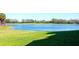 Scenic view of a lake surrounded by lush green grass and trees, offering a peaceful natural landscape at 6509 Grand Estuary Trl # 201, Bradenton, FL 34212