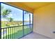 Screened lanai with views of a lake and lush greenery, providing a private outdoor retreat at 6509 Grand Estuary Trl # 201, Bradenton, FL 34212