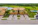 Aerial view of the community featuring tropical landscaping, lake views, and golf course at 6923 Grand Estuary Trl # 101, Bradenton, FL 34212