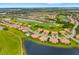 Aerial view of a lush community with golf course, villas, and lakes providing tranquil views at 6923 Grand Estuary Trl # 101, Bradenton, FL 34212