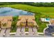 Aerial view of the community featuring tropical landscaping, lake views, and a golf course at 6923 Grand Estuary Trl # 101, Bradenton, FL 34212