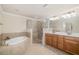 Primary bathroom features large soaking tub, glass enclosed shower, and double vanity at 6923 Grand Estuary Trl # 101, Bradenton, FL 34212