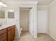 Bathroom featuring sink vanity, toilet, and closet with neutral paint and tile flooring at 6923 Grand Estuary Trl # 101, Bradenton, FL 34212
