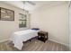 Bedroom features a ceiling fan, carpet flooring, and a large window allowing natural light at 6923 Grand Estuary Trl # 101, Bradenton, FL 34212