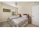 Bedroom with carpet flooring, a ceiling fan, and twin beds with floral bedspreads at 6923 Grand Estuary Trl # 101, Bradenton, FL 34212