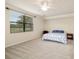 Spacious bedroom with neutral carpeting and large window overlooking the golf course at 6923 Grand Estuary Trl # 101, Bradenton, FL 34212