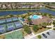 An aerial view shows the community sports facilities including tennis and basketball and parking at 6923 Grand Estuary Trl # 101, Bradenton, FL 34212