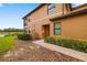 Exterior side view of the townhome showcasing the entrance and landscaping at 6923 Grand Estuary Trl # 101, Bradenton, FL 34212