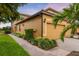 Inviting home exterior featuring a two-car garage, lush landscaping, and a charming brick walkway at 6923 Grand Estuary Trl # 101, Bradenton, FL 34212