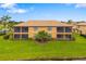 Exterior of the condo with screened in lanais overlooking well maintained green space at 6923 Grand Estuary Trl # 101, Bradenton, FL 34212