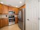 Traditional kitchen features stainless steel appliances and stylish tile backsplash at 6923 Grand Estuary Trl # 101, Bradenton, FL 34212