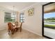 Kitchen eat-in nook with pond view and sliding glass doors to lanai at 6923 Grand Estuary Trl # 101, Bradenton, FL 34212