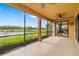 Spacious screened lanai with ceiling fans, lake views, and access to the main house at 6923 Grand Estuary Trl # 101, Bradenton, FL 34212