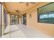 Screened-in patio with ceiling fans, sliding glass doors, and neutral flooring at 6923 Grand Estuary Trl # 101, Bradenton, FL 34212