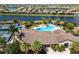 This aerial shot showcases a pool and clubhouse in a community with waterways and single Gathering homes at 6923 Grand Estuary Trl # 101, Bradenton, FL 34212