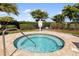 A round spa sits in a brick patio area surrounded by greenery at 6923 Grand Estuary Trl # 101, Bradenton, FL 34212