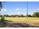 Expansive sports field with soccer goals, lush green grass, and scattered trees under a clear blue sky for recreation at 6923 Grand Estuary Trl # 101, Bradenton, FL 34212
