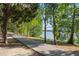 Picturesque walking path alongside the lake with lush greenery and shade trees for tranquil outdoor recreation at 6923 Grand Estuary Trl # 101, Bradenton, FL 34212