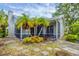 Backyard screened-in patio with tropical landscaping, pea gravel, and stepping stones at 6929 Stetson Street Cir, Sarasota, FL 34243