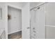 White bathroom with a tiled shower and a glimpse into an adjoining room at 6929 Stetson Street Cir, Sarasota, FL 34243