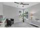 Neutral bedroom with a corner window and a ceiling fan at 6929 Stetson Street Cir, Sarasota, FL 34243