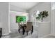 Dining room showcases a modern light fixture, neutral paint and large art piece at 6929 Stetson Street Cir, Sarasota, FL 34243