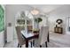 Open dining area features neutral walls, gray carpet, and a large arched window at 6929 Stetson Street Cir, Sarasota, FL 34243