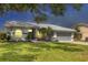 Charming single-story home featuring a well-maintained lawn and inviting curb appeal with beautiful landscaping at 6929 Stetson Street Cir, Sarasota, FL 34243
