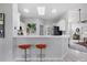 Bright kitchen featuring white cabinetry, a breakfast bar with seating, and seamless access to the living area at 6929 Stetson Street Cir, Sarasota, FL 34243